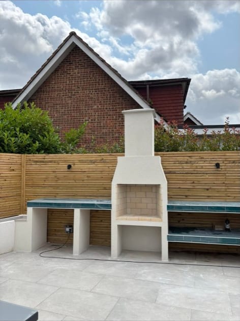 Rendered garden BBQ and fireplace feature with rendered fence panels in Kent
