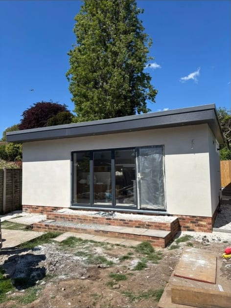 White rendered garden room with bifold doors in Kent