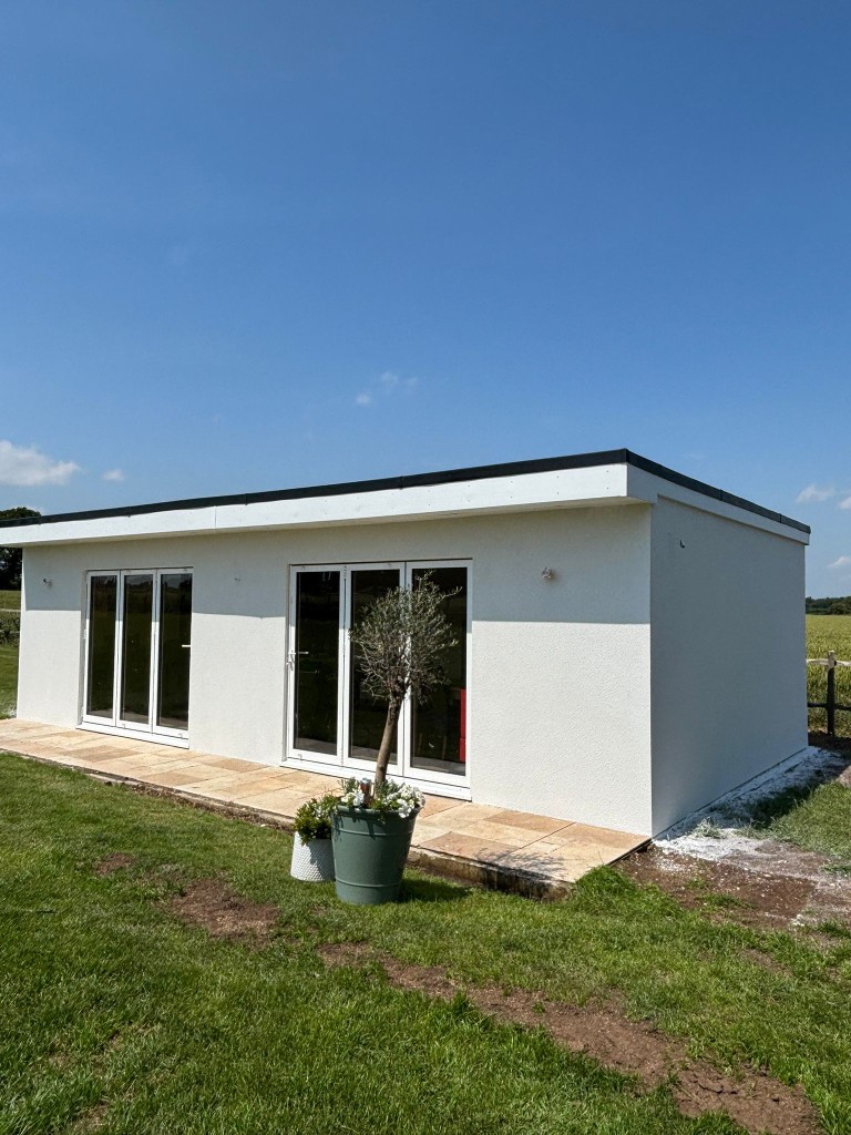 Bungalow finished in smooth white silicone render with bifold doors in Kent