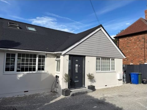 House finished in smooth white silicone render with a modern entrance in Kent
